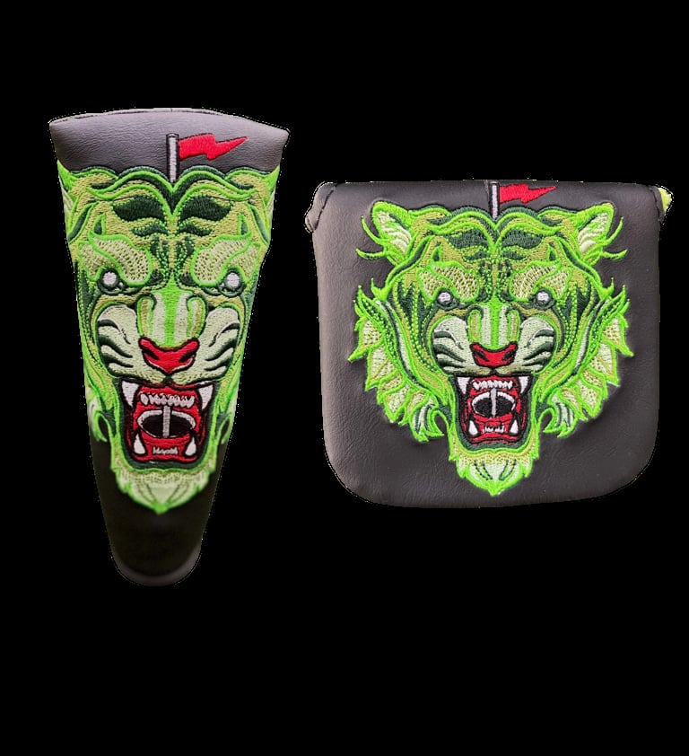 Lime green embroidered demon face designs on a putter cover and headcover with red flag and black base